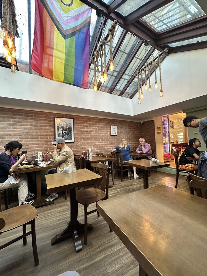 Wooden tables under the skylight in the dining room.
