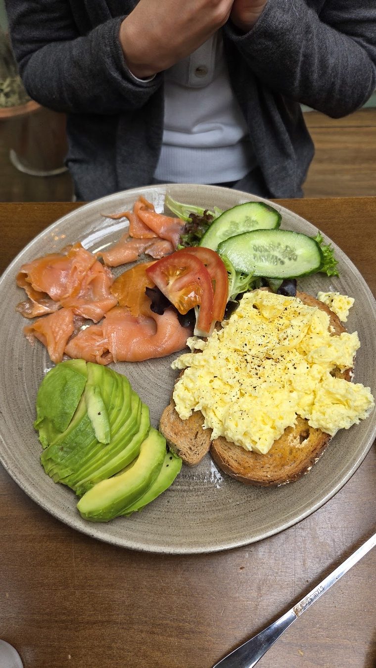 Smoked salmon with scrambled eggs and avocado on toast.