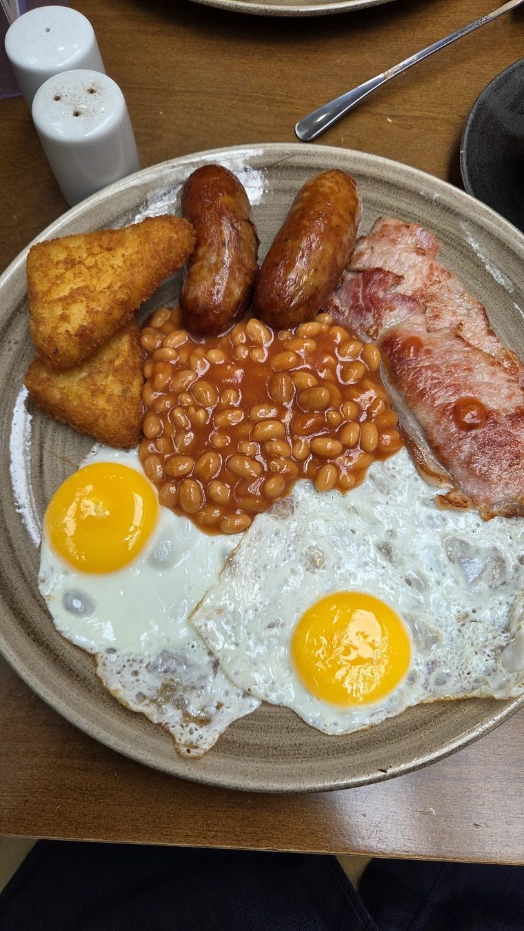 Sausages, bacon, hash browns, beans and fried eggs.
